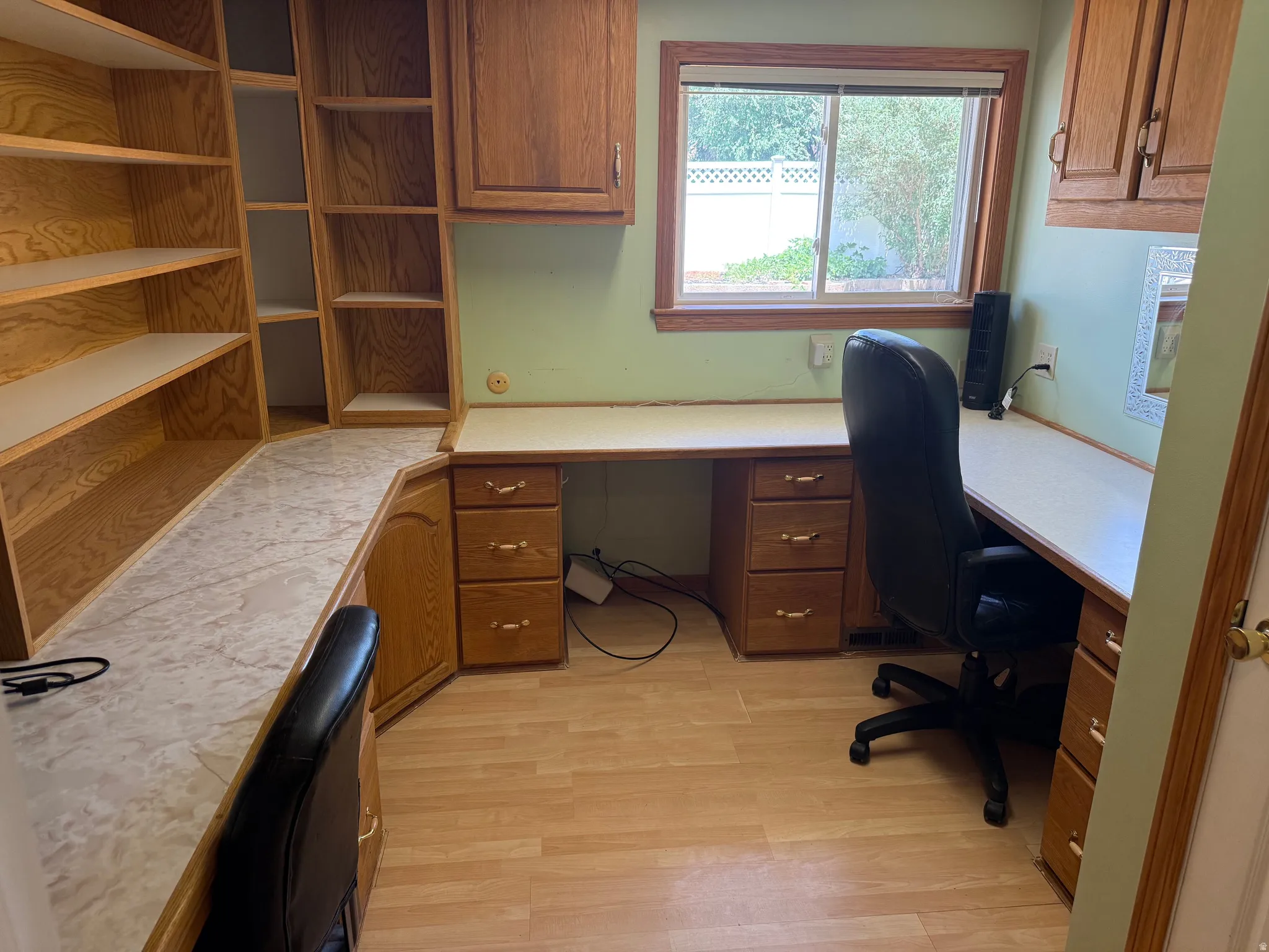 Built-in oak cabinetry with integrated shelving and desk surfaces