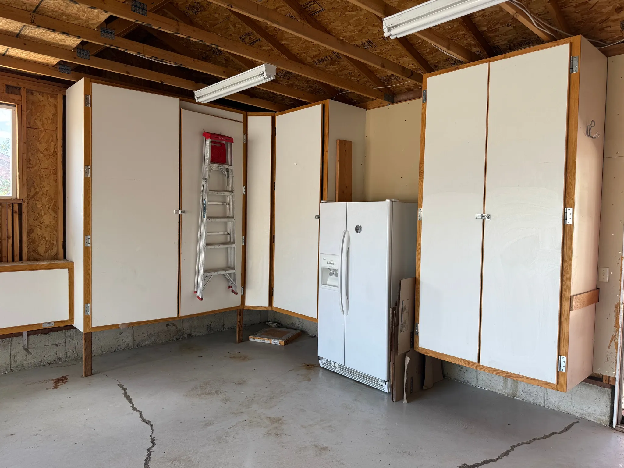 Integrated storage cabinetry with light wood-finish framing