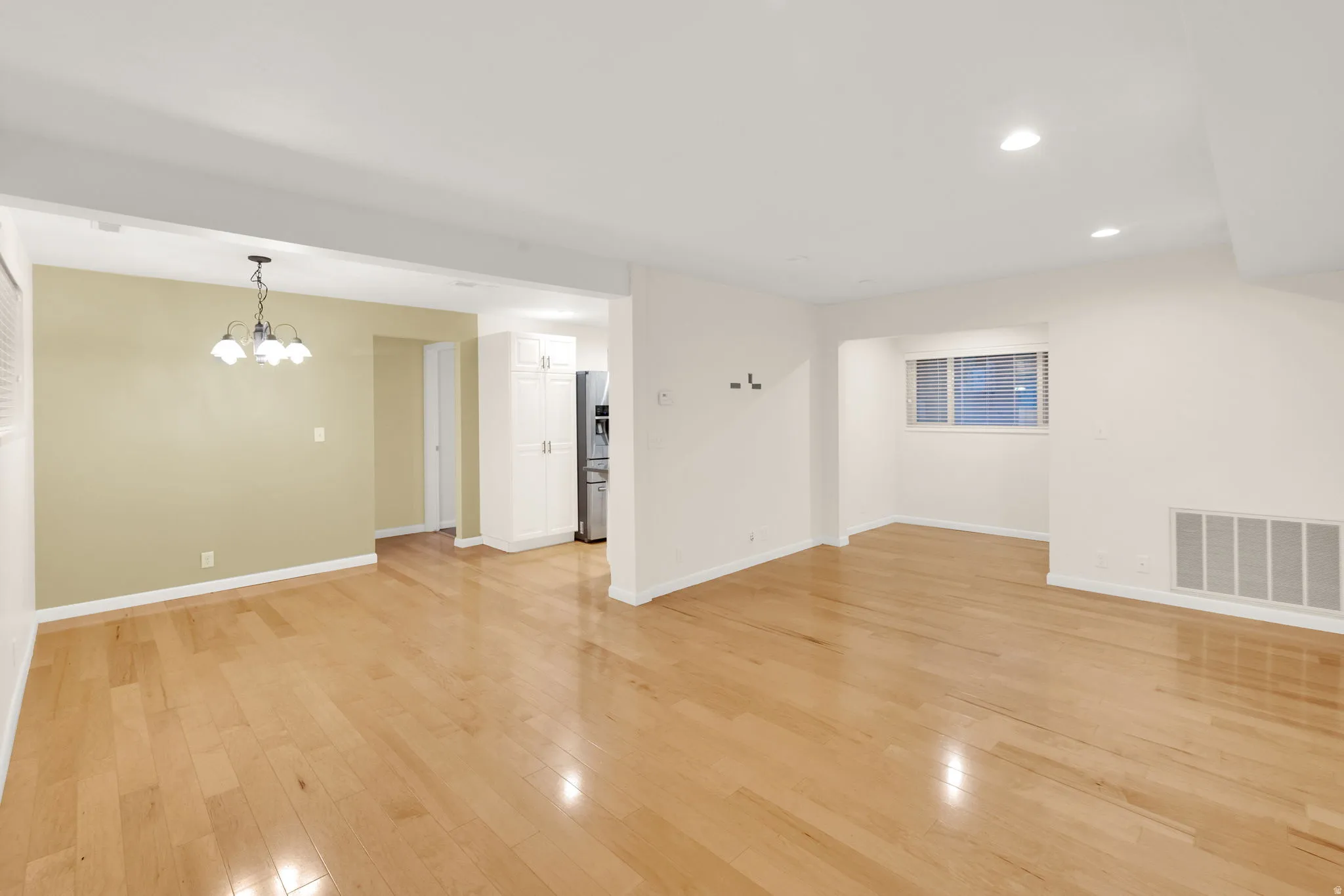 Open concept living space featuring wood-finish flooring