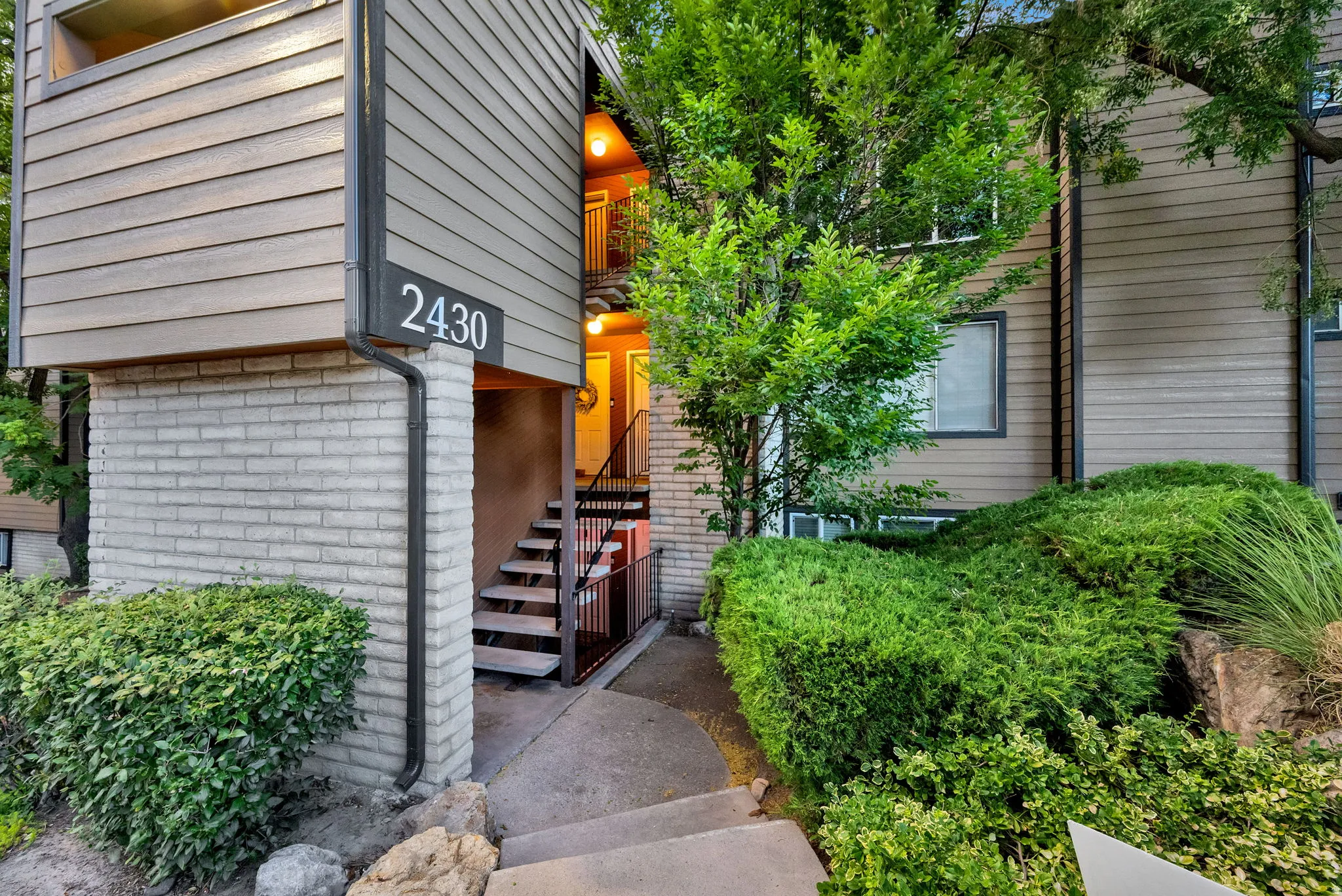 Exterior facade featuring horizontal siding and light-toned brickwork