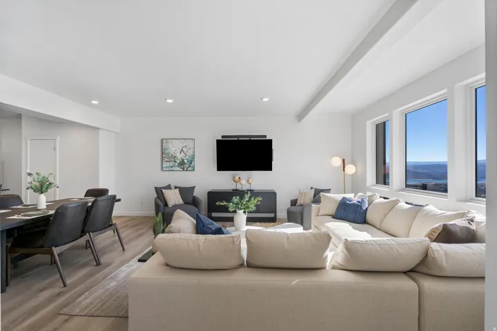 Open-concept living space featuring wood-finish flooring and recessed lighting