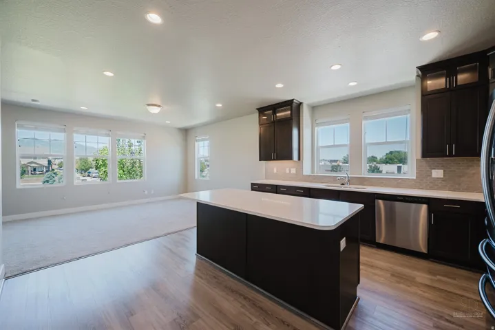 Open-concept living space with a central kitchen island and abundant natural light