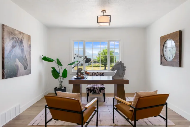 Spacious room with wood-finish flooring and a large multi-pane window