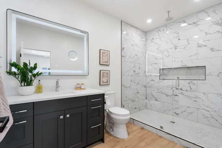 Bathroom featuring a spacious walk-in shower with large format tile and a recessed niche
