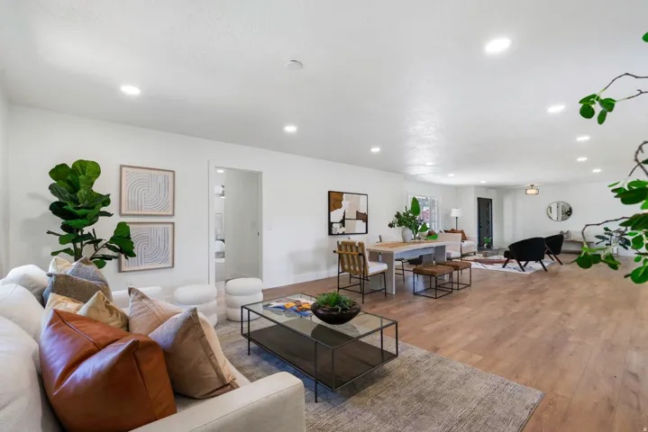 Spacious interior featuring wood-finish flooring, recessed lighting, and white walls