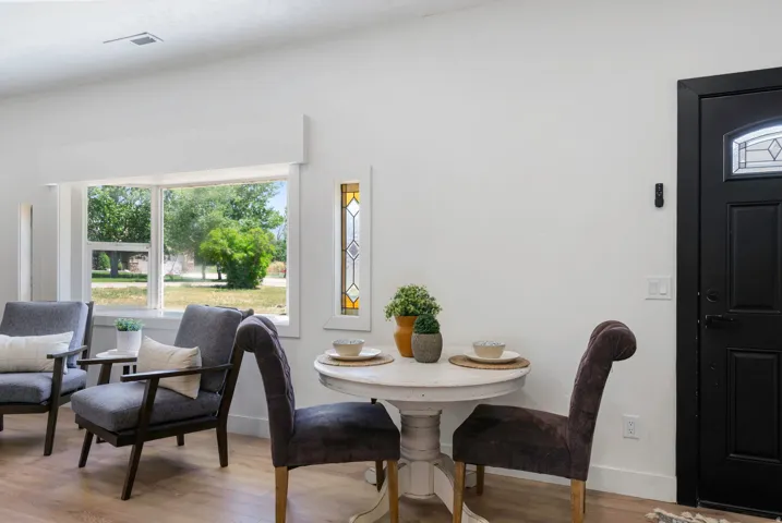 Bright living space featuring wood-finish flooring and a front-facing window