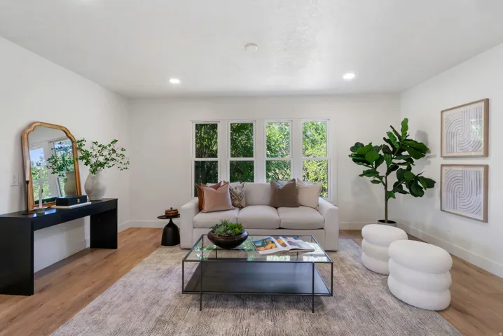 Living area featuring wood-finish flooring and recessed lighting