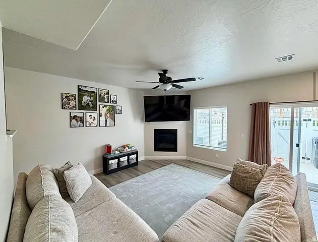 Living area featuring wood-finish flooring and a corner fireplace