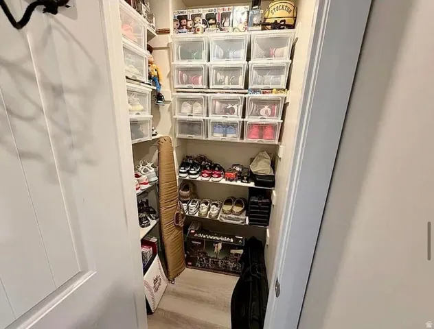 Custom closet storage system featuring multiple shelving units and wood-finish flooring