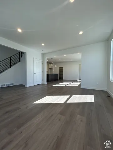 Spacious interior featuring wood-finish flooring, recessed ceiling lighting, and a contemporary open-concept layout