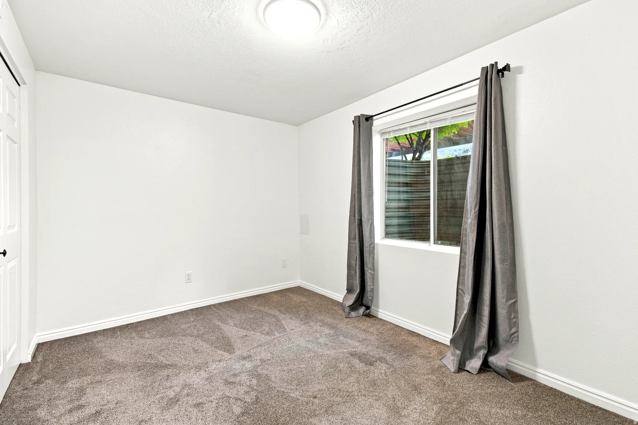 Room featuring neutral wall finishes and carpeted flooring