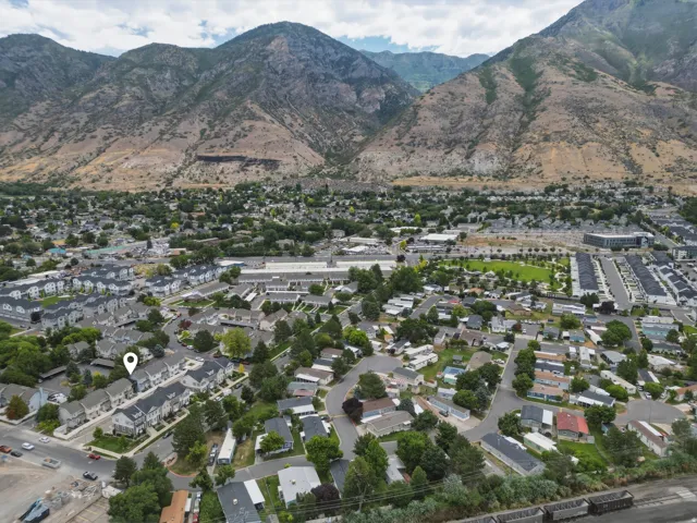 Aerial perspective showcasing a residential community with mountainous backdrop