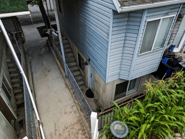 Concrete walkway with flanking stairs and metal railings