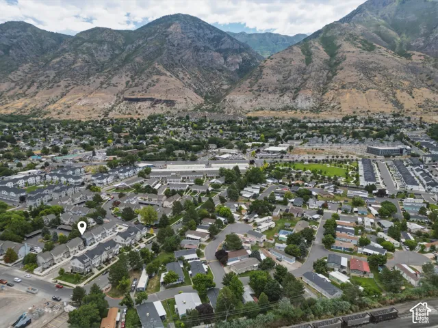 Aerial perspective showcasing a residential community with mountainous backdrop