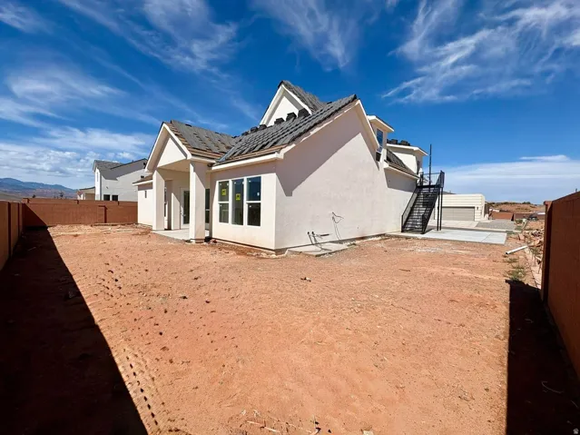 Stucco exterior with multiple gables and a covered patio