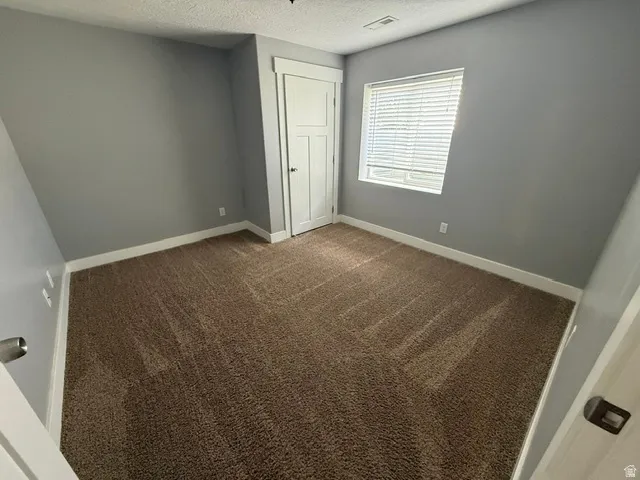 Neutral tone walls with white trim and brown carpeting