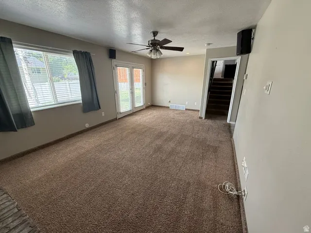 Living area featuring plush carpeting and neutral wall tones