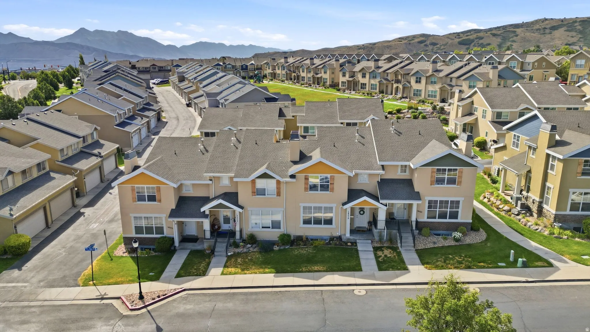 Townhome community featuring neutral-toned exteriors with contrasting trim and gabled roofs