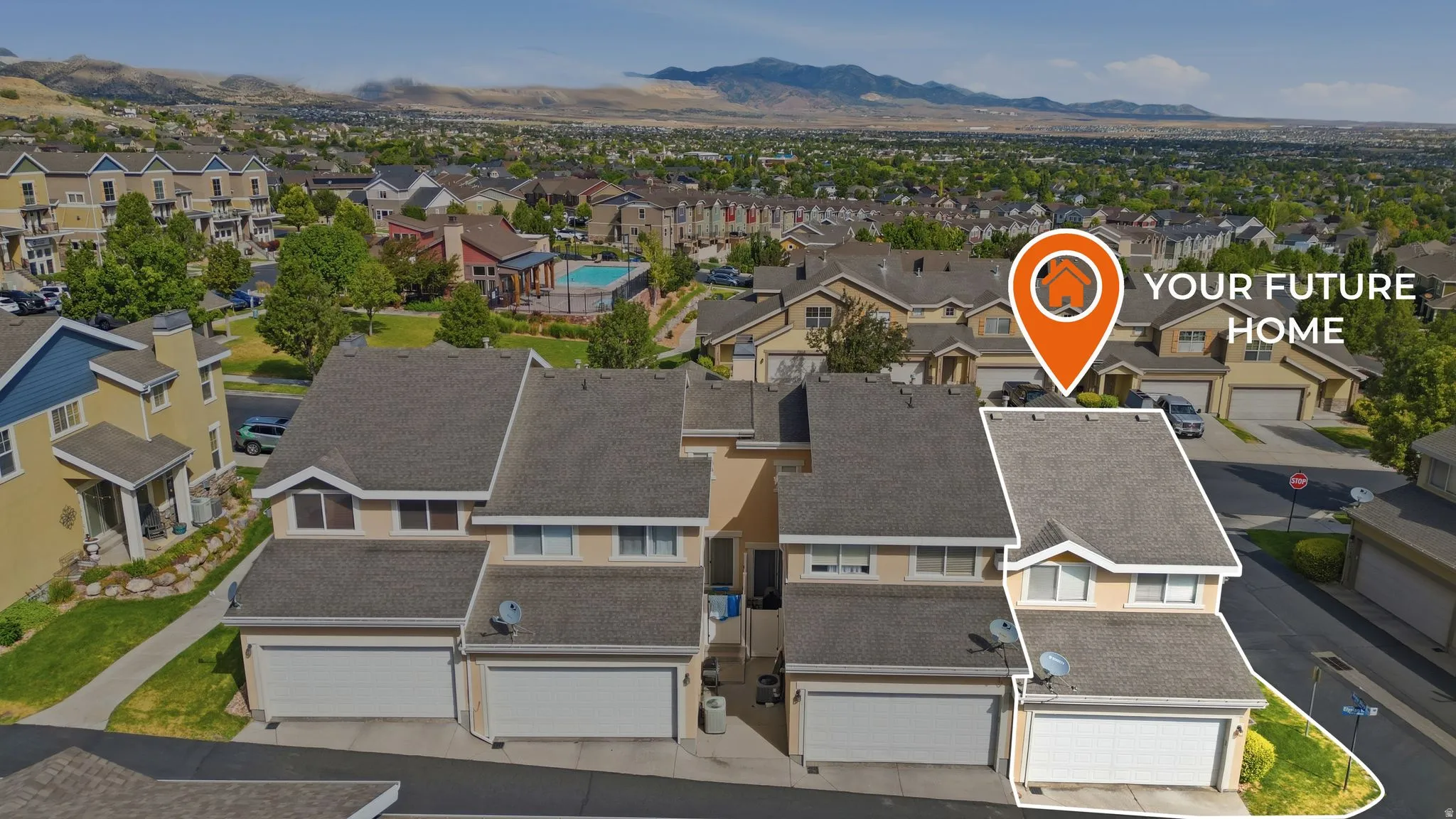 Two-story townhome with an attached garage and light stucco exterior