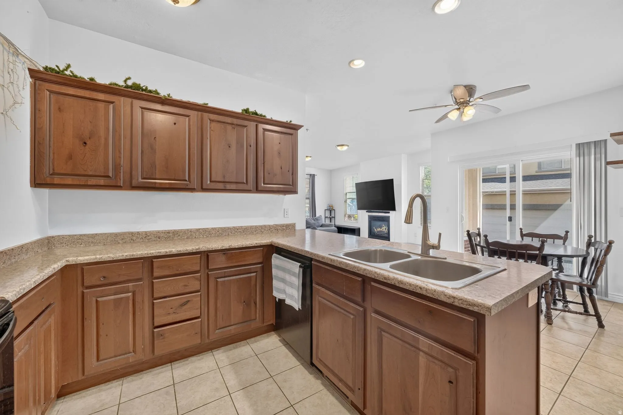 Kitchen featuring wood cabinetry, light-toned countertops, and tile flooring
