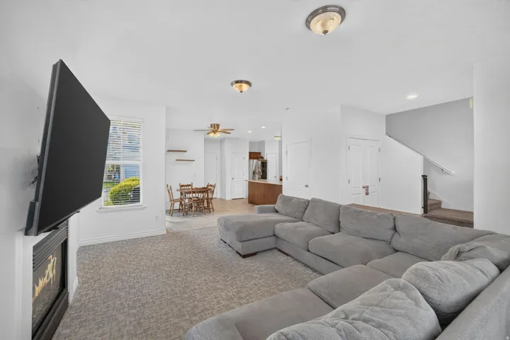 Spacious living area featuring patterned carpeting and a built-in fireplace