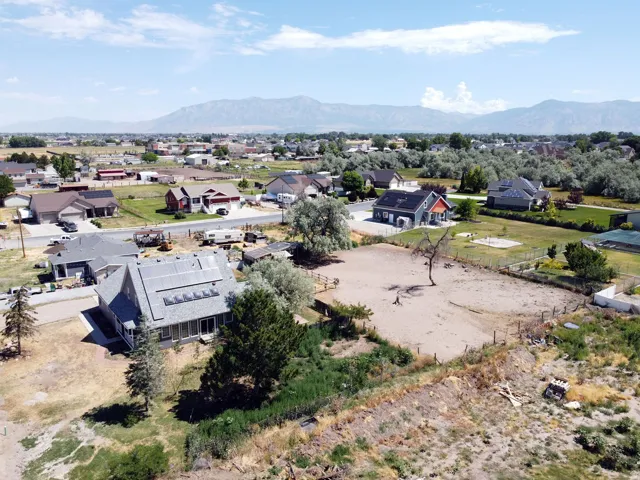 Expansive property featuring a large open lot with surrounding residences