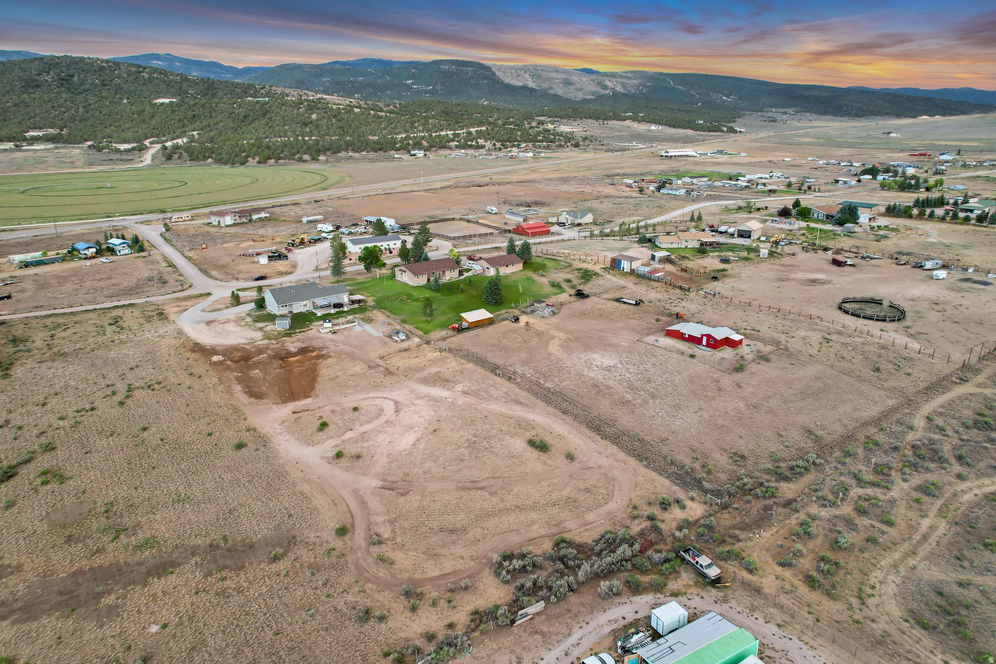 Expansive rural property featuring an established residence, multiple outbuildings, and surrounding undeveloped land