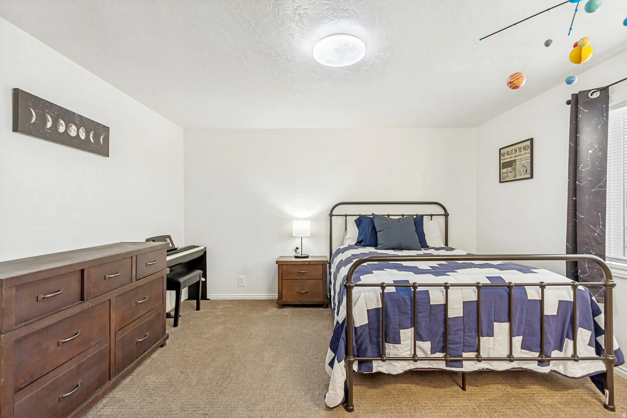 Bedroom featuring neutral wall paint, carpet flooring, a window with blinds, and a flush-mount ceiling light fixture