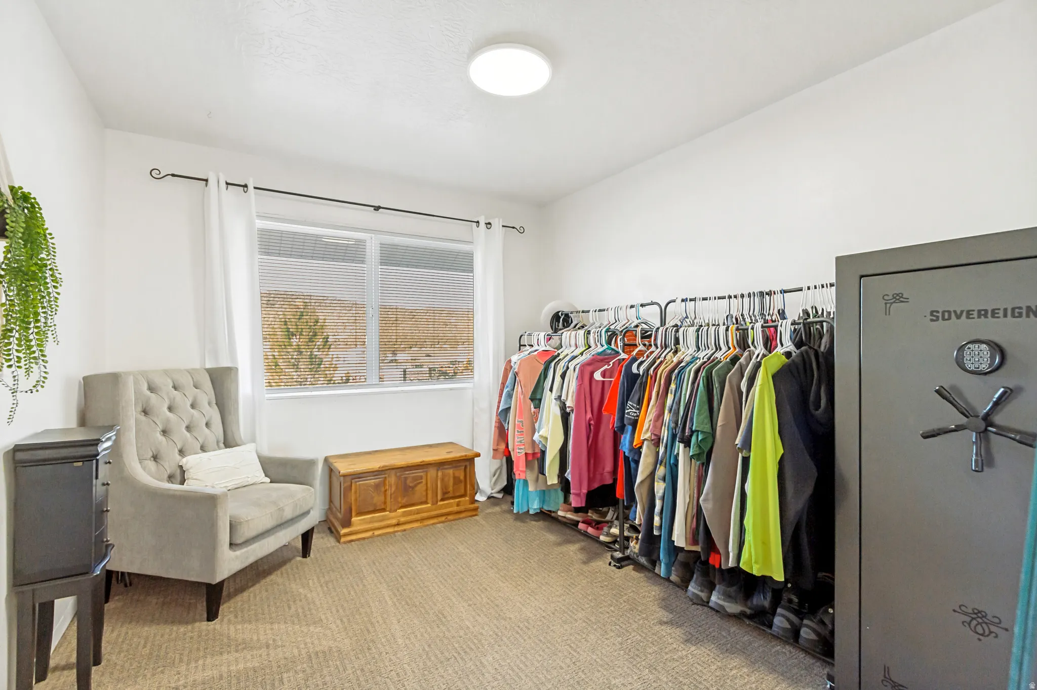 Spacious room featuring neutral carpeting, a large window, and recessed ceiling lighting