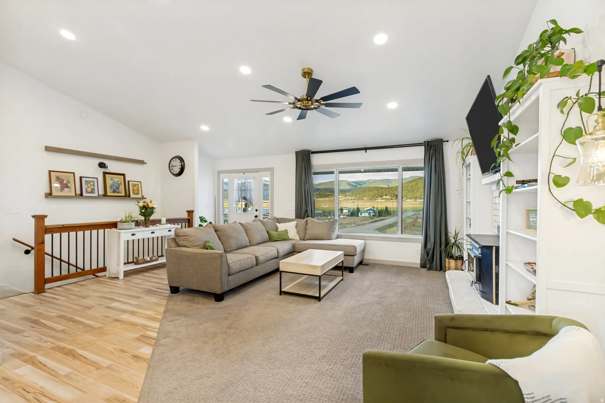 Open-concept living space featuring vaulted ceilings, recessed lighting, and a contemporary ceiling fan