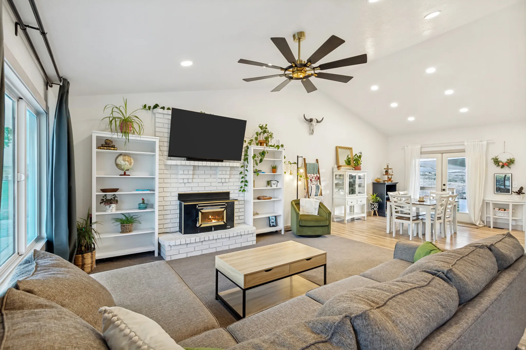 Expansive living area with vaulted ceilings and recessed lighting
