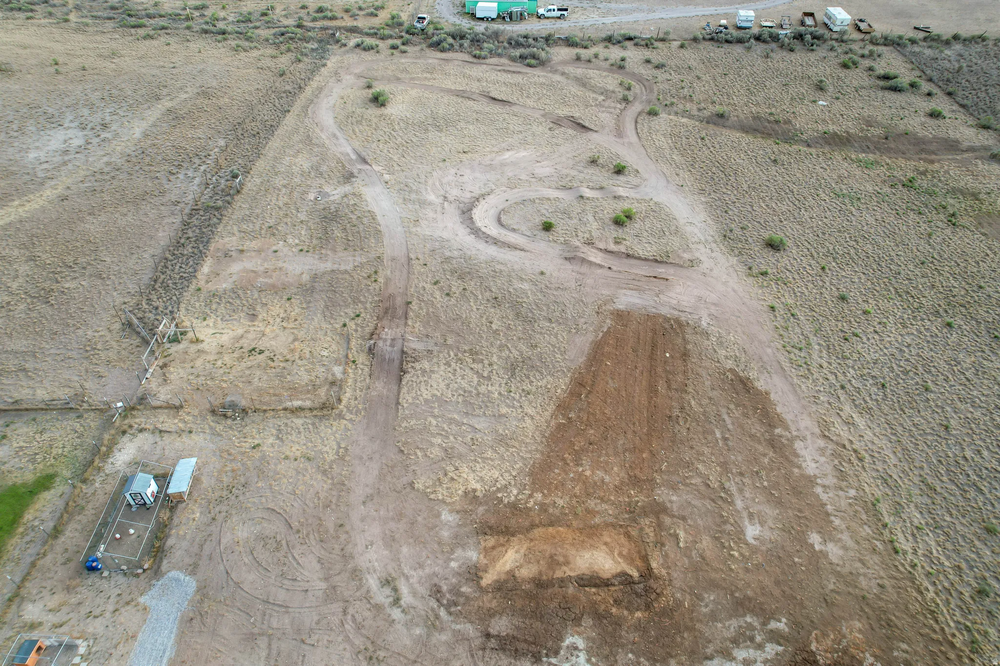 Expansive undeveloped land featuring natural terrain with varied vegetation and visible ground preparation