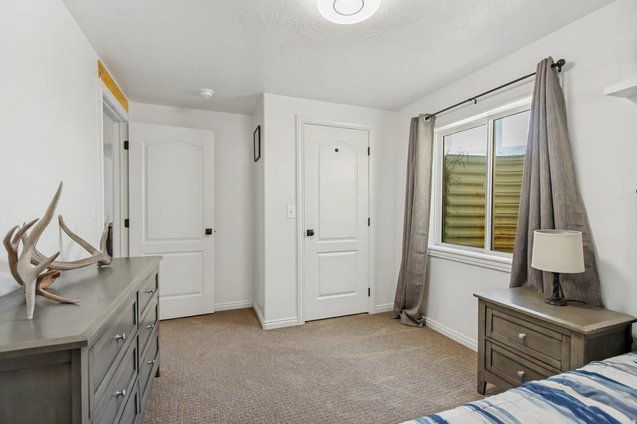 Neutral wall tones complement the carpeted flooring