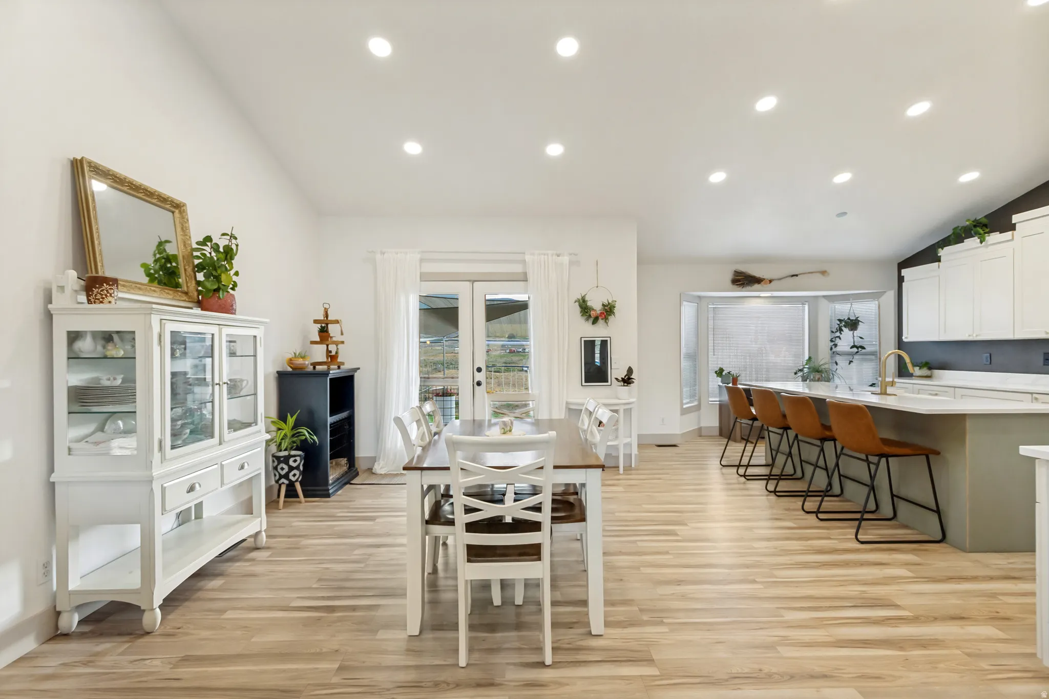 Open-concept living space with vaulted ceilings and recessed lighting