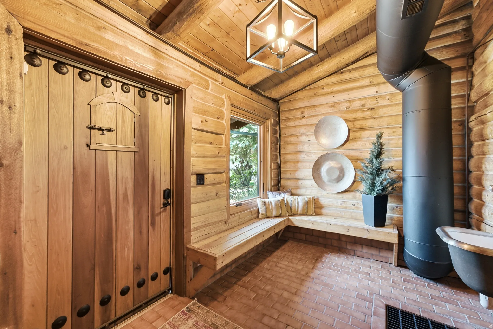 Rustic entryway featuring a solid wood door with decorative hardware