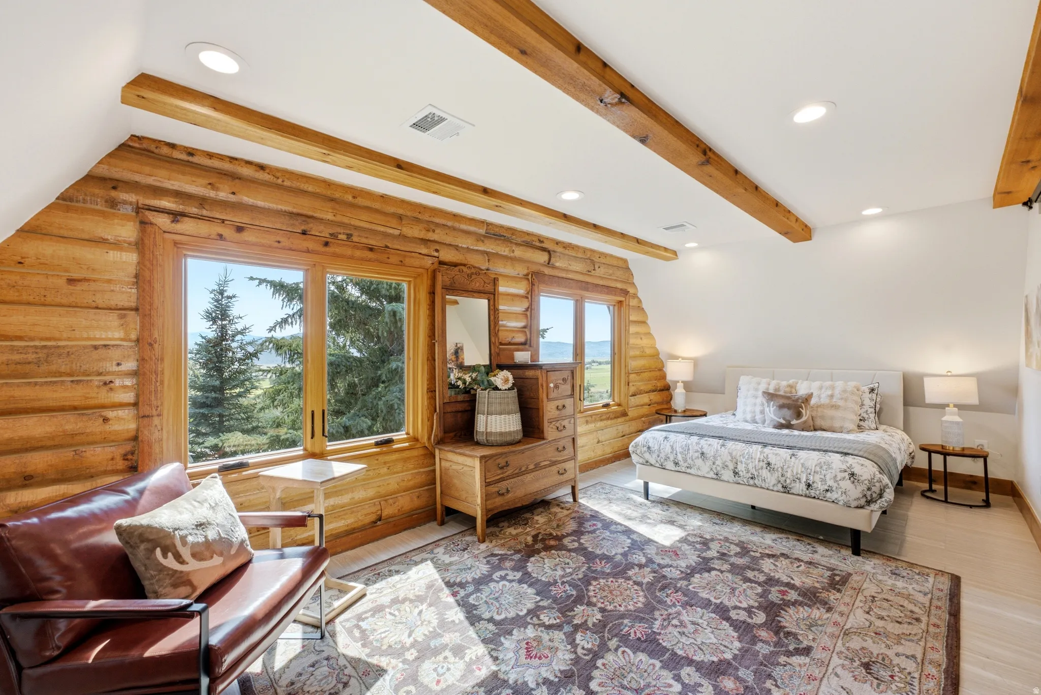 Vaulted ceiling featuring exposed wood beams and recessed lighting
