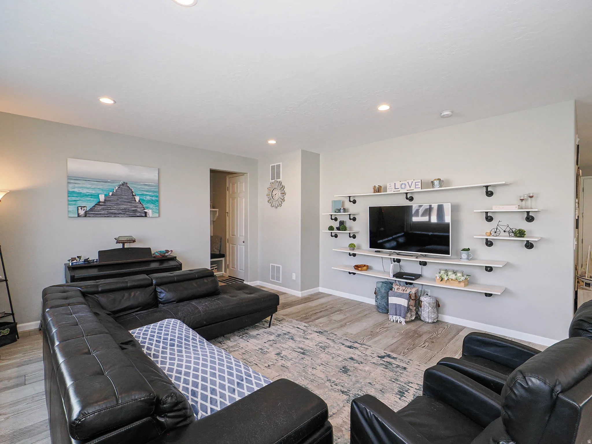 Living area featuring recessed lighting and wood-finish flooring