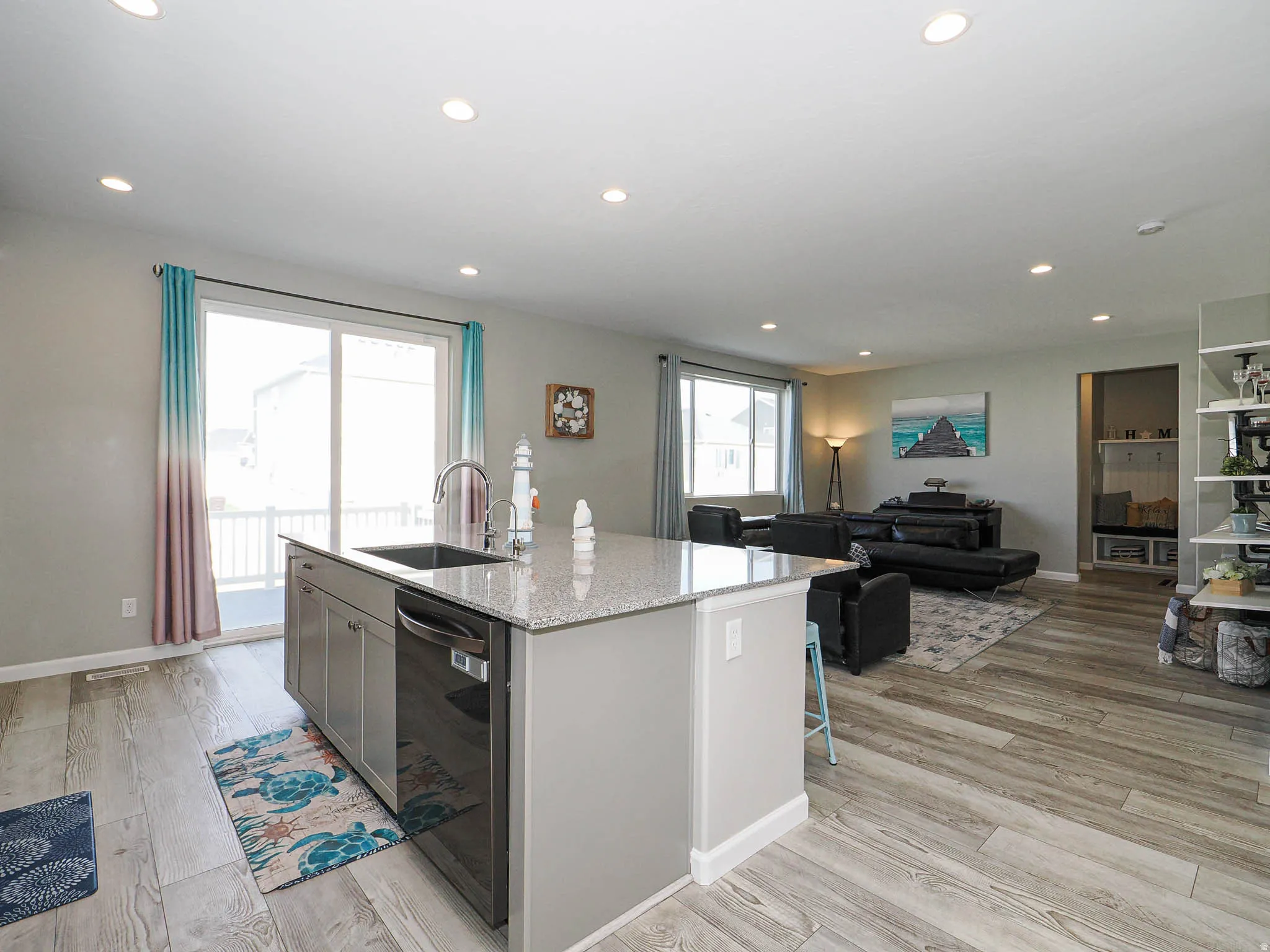 Open-concept living space featuring wood-finish flooring throughout