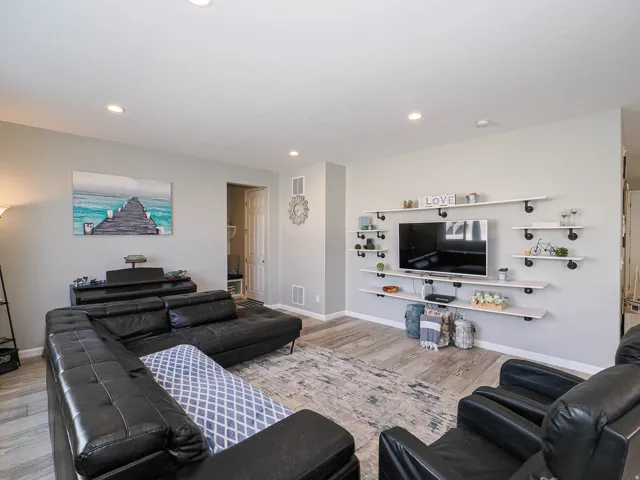 Living area featuring recessed lighting and wood-finish flooring