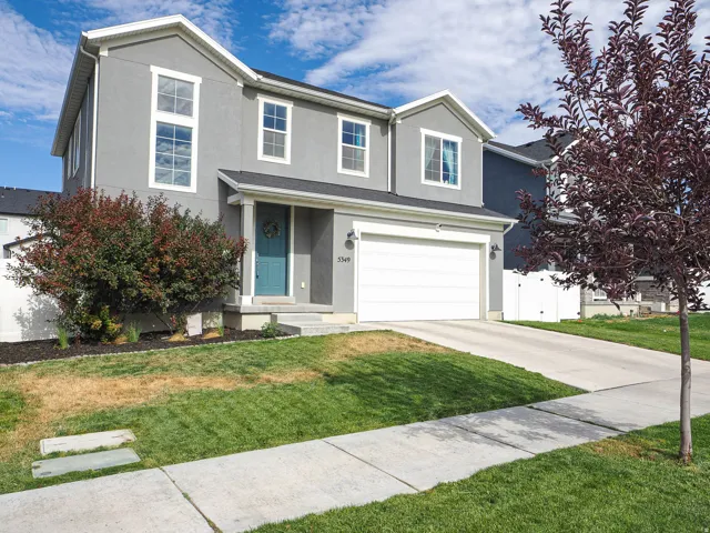 Contemporary two-story residence featuring a gray stucco exterior with white trim
