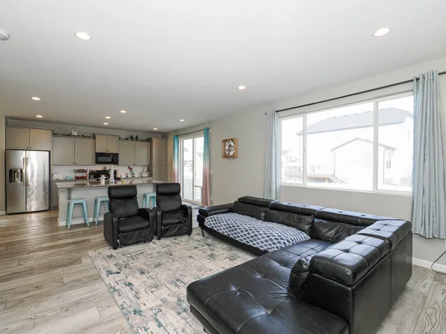 Open-concept living area featuring wood-finish flooring and recessed ceiling lights