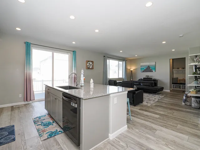 Open-concept living space featuring wood-finish flooring throughout