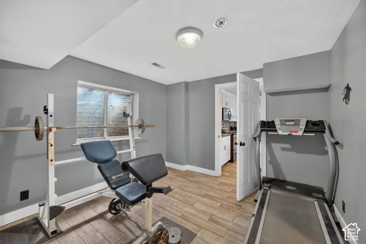 Versatile bonus room featuring wood-finish flooring, recessed lighting, and a window for natural light