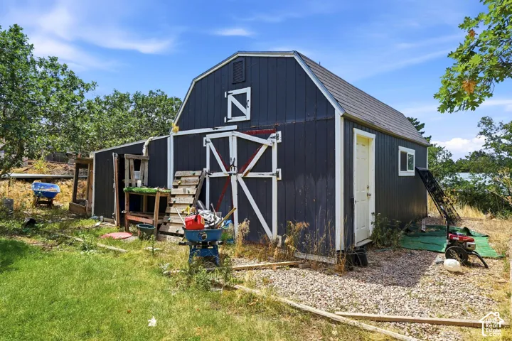 Barn structure with dark siding and white trim detailing