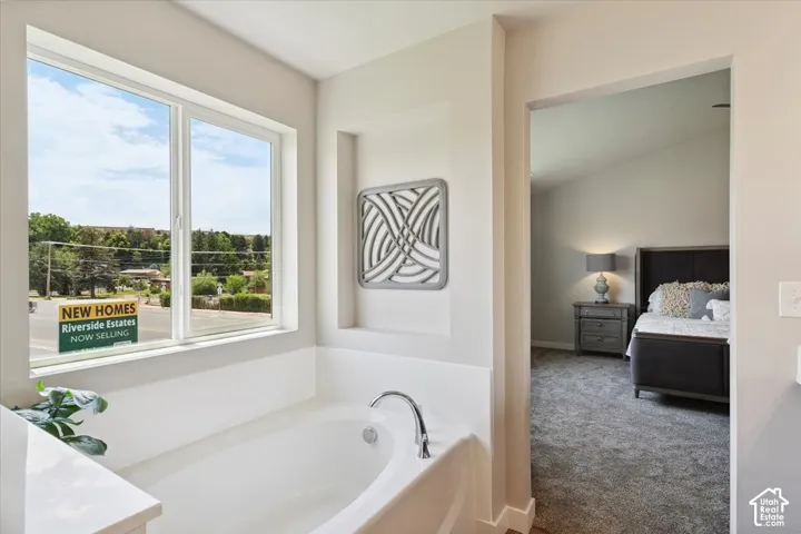 Primary bathroom featuring a soaking tub with chrome fixtures