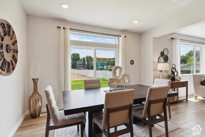 Dining area featuring ample natural light, recessed lighting, light wood-finish flooring, and white walls