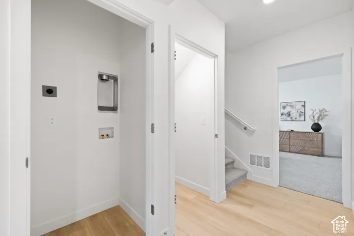 Dedicated laundry alcove with electrical and plumbing hookups