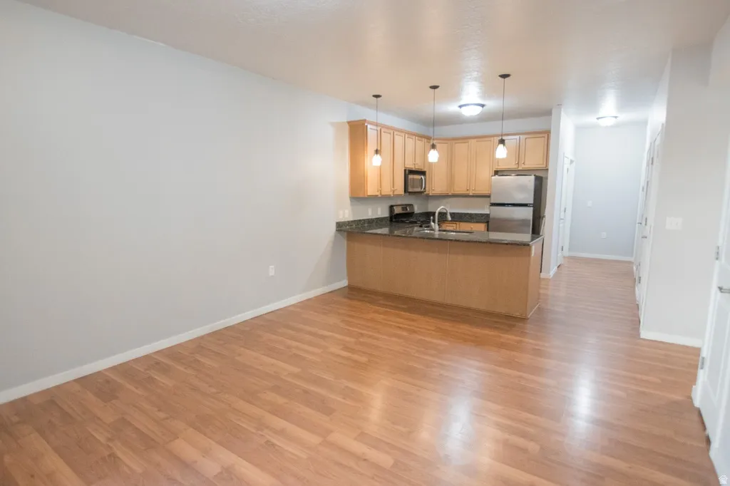 Open-concept living space featuring wood-finish flooring