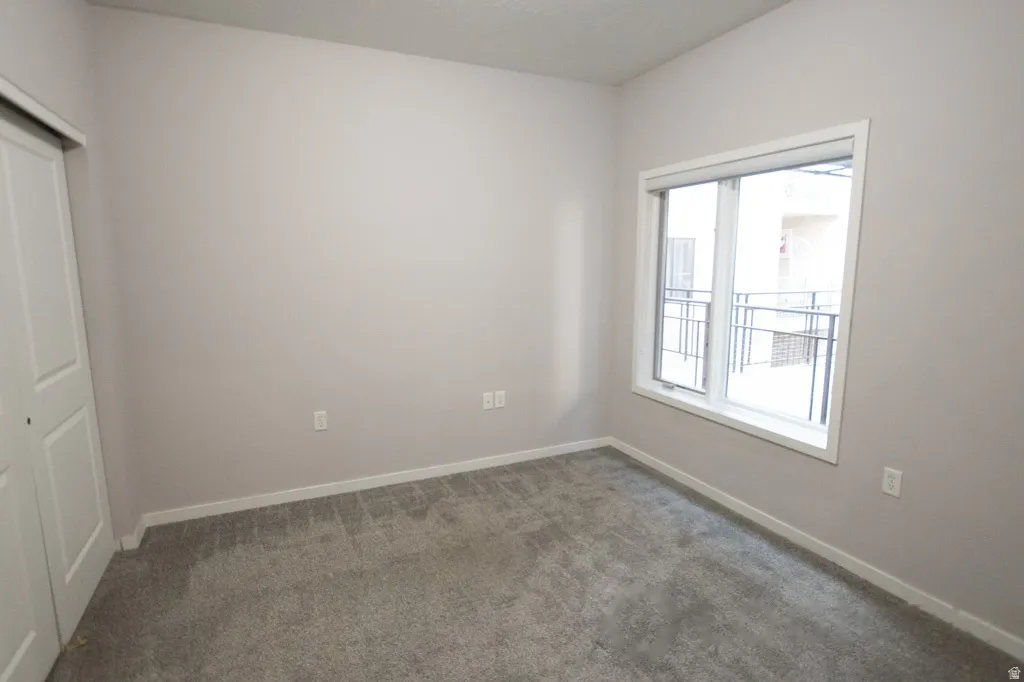 Neutral-toned walls complement the gray carpeting