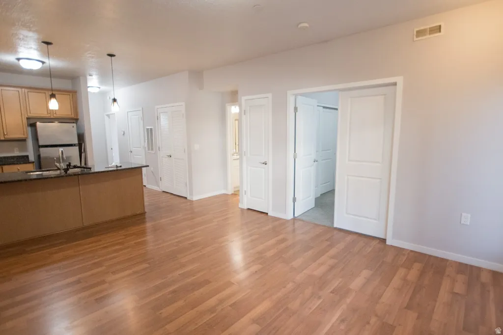 Open-concept living area featuring wood-finish flooring